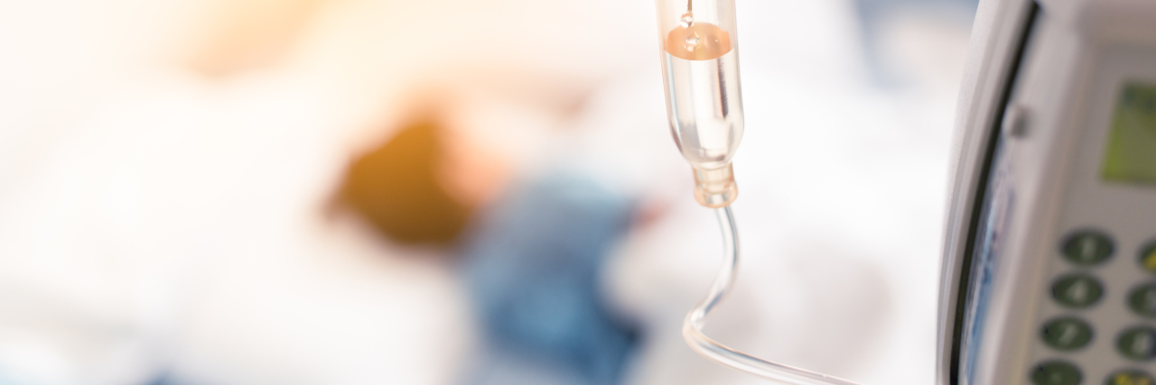 The Goal of Reaching 100 Days When Your Child Has a Rare Disease a sick child lying in a hospital bed with a saline drip