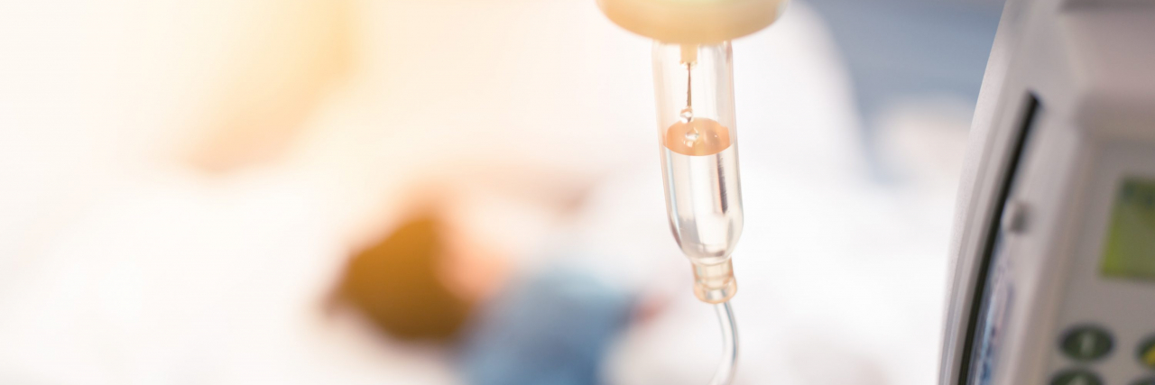 What I Want Friends and Family to Know When Our Child Is Undergoing Surgery A child lying in a hospital bed with a saline drip in foreground