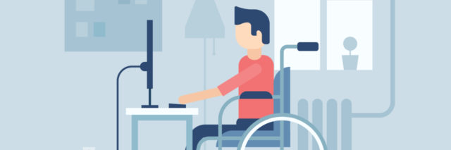 A man in a wheelchair on a computer