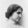 Black and white photo of Helen Keller with her hair in a bun.