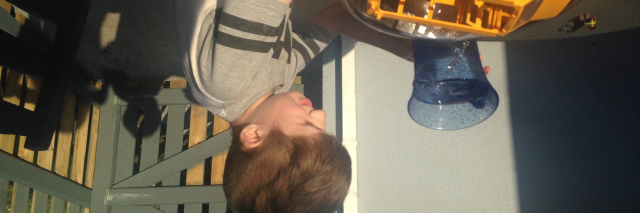 Tips to Help Your Autistic Siblings With Distance Learning Freya's brother playing with sensory toys.