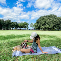 the author sitting outside on a blanket with her dog