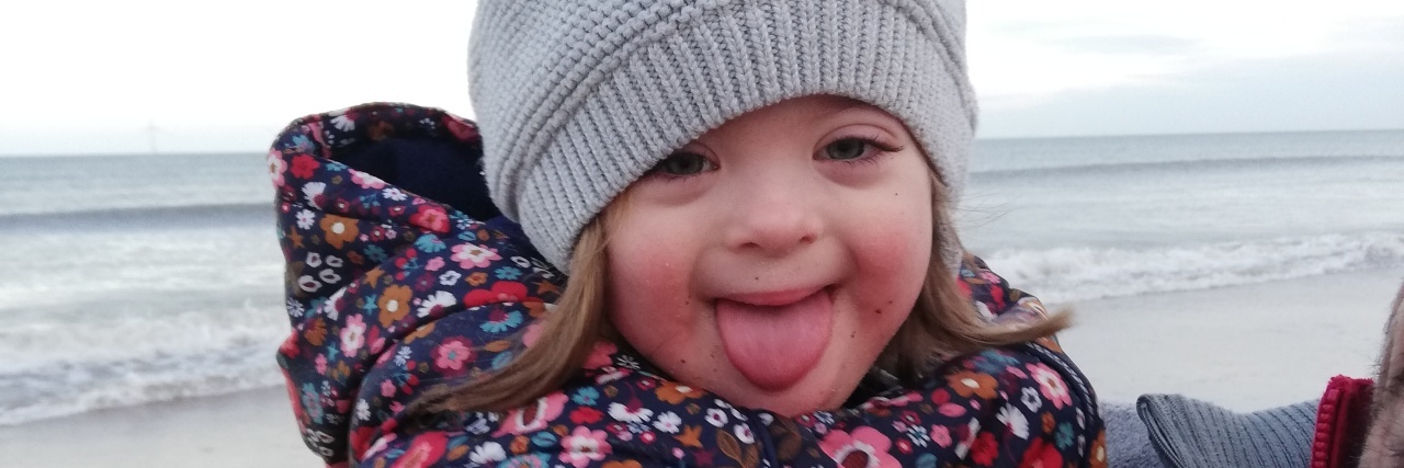 Why the Prenatal Testing System in the U.K. Is Ableist and Dangerous Rachel's daughter with Down syndrome smiling.