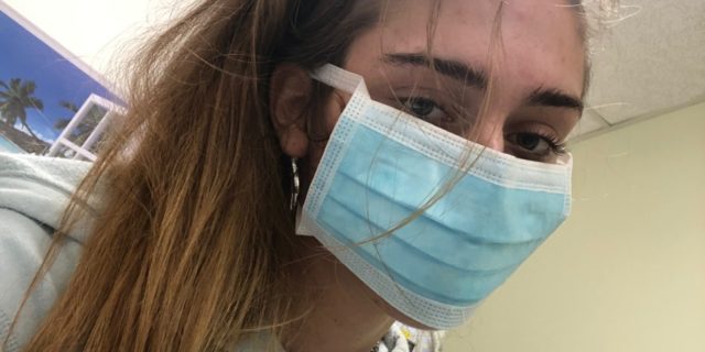 How COVID-19 Has Impacted My Life as a Psychiatric Hospital Patient photo of the contributor inside a psychiatric hospital during the coronavirus pandemic, wearing a blue face mask and looking into the camera