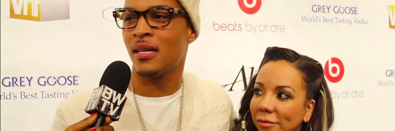 Rapper T.I. and his wife Tiny on the red carpet at an event being interviewed