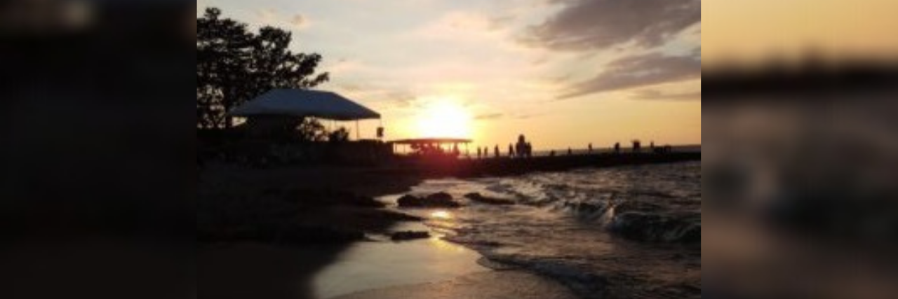 When Mania Is Worse in the Morning and Depression Worse at Night A sunset over the water with the beach on the left and water to the right