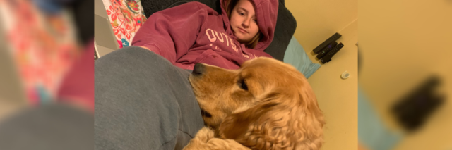 photo of the contributor with her emotional support dog, a golden labrador
