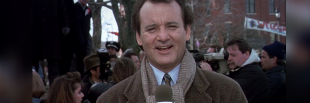 Bill Murray talking into a microphone in "Groundhogs Day"