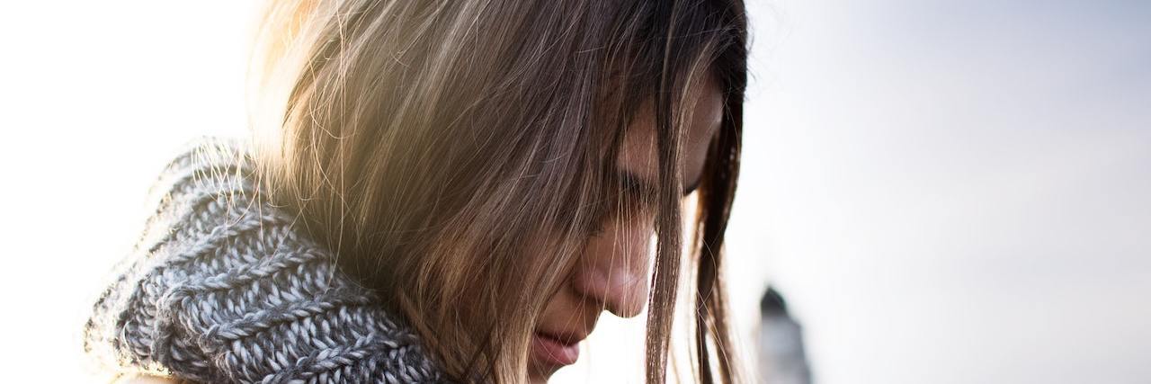 Woman with long hair wearing scarf outside