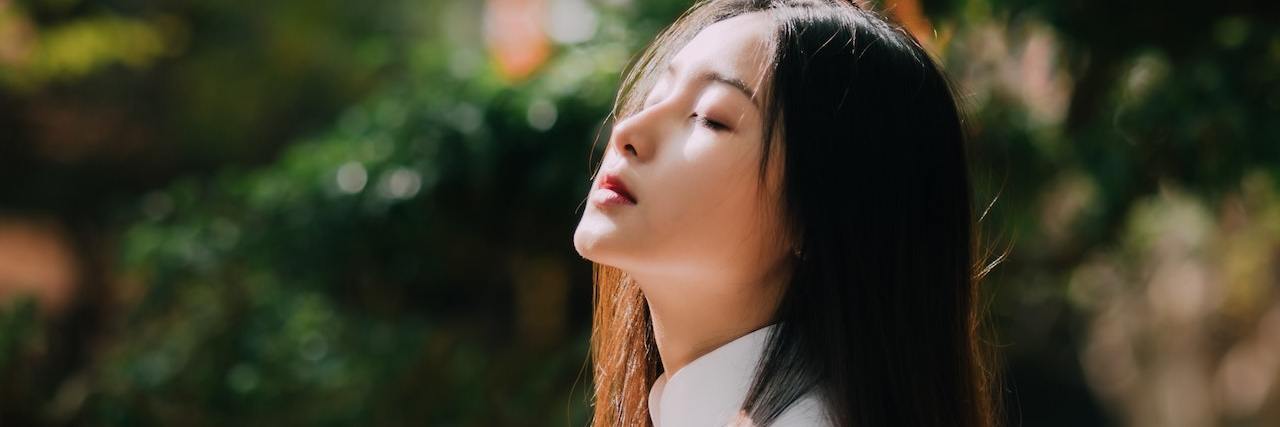 Therapist Asked Me, 'Why Are You in a Rush to Kill Yourself?' A woman standing at a balcony looking up