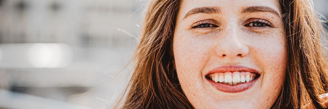 Finding Humor in Chronic Illness Challenges woman smiling