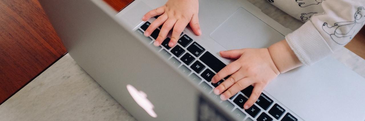 Remote Jobs for People With Disabilities and Chronic Illnesses World's smallest employee (a baby) types on an open laptop