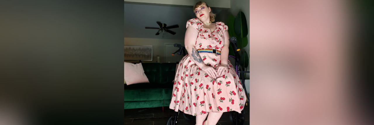 Fatphobia Can Be Life-Threatening When You Have Chronic Illness Contributor sitting on rollator wearing a dress with cherries and red shoes