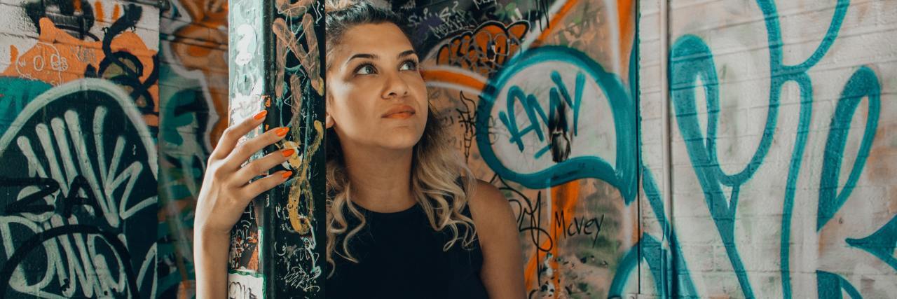 photo of woman in room filled with graffiti