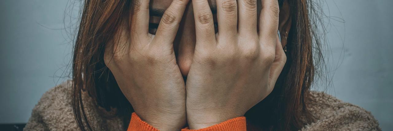 Inappropriate Things to Say to Trauma Survivors photo of upset woman covering eyes, sad or scared