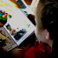 Elena's daughter, who has Down syndrome, reading a book.