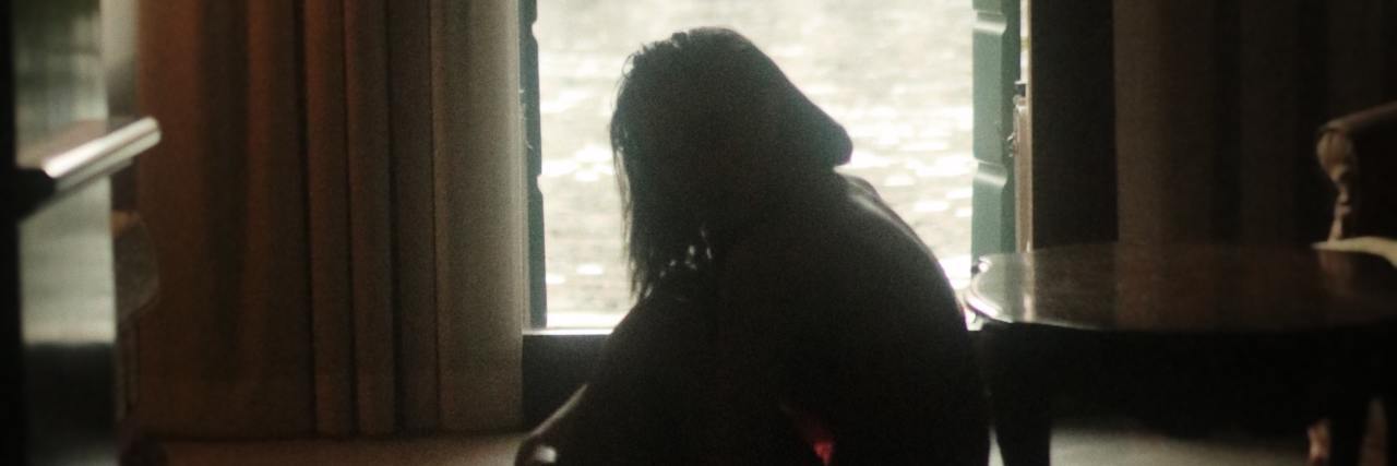 The Difference Between Depression Days and Anxiety Days photo of woman sitting on floor beside window