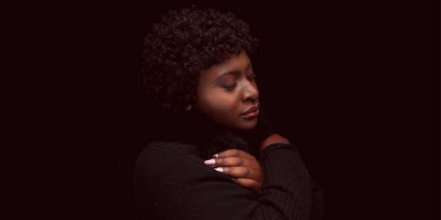 What Other Disasters Taught Me About Secondary Trauma After the Capitol Insurrection photo of a woman with her eyes closed, arms crossed on her chest, looking thoughtful