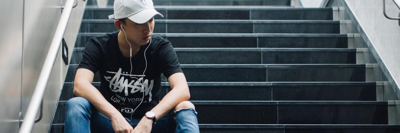 What Do I Do if I've Relapsed in My Smoking Addiction? photo of man wearing a white hat sitting on subway stairs