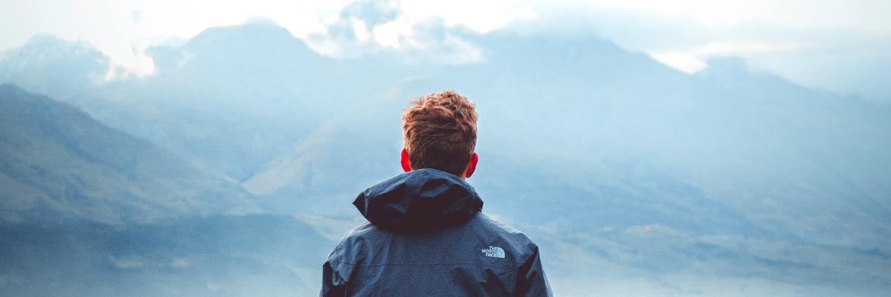 Can There Be Positives and Negatives to Mental Health Diagnosis Labels photo of man in a field staring off into distant mountains