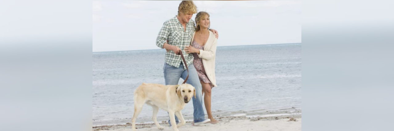 Photo of Owen Wilson and Jennifer Anniston with dog on a beach