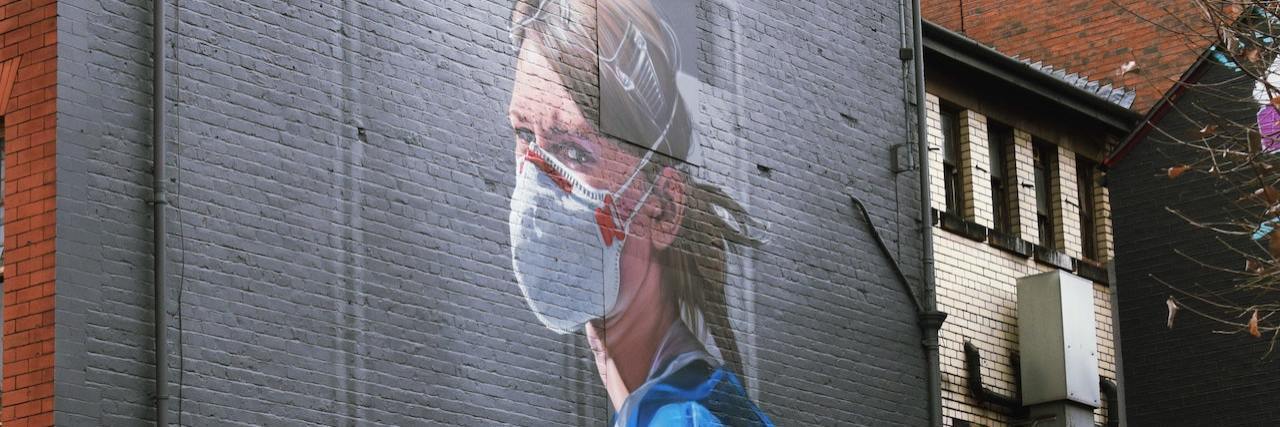 How COVID-19 Is Similar to Life With a Rare Disease Street art of a nurse wearing a mask