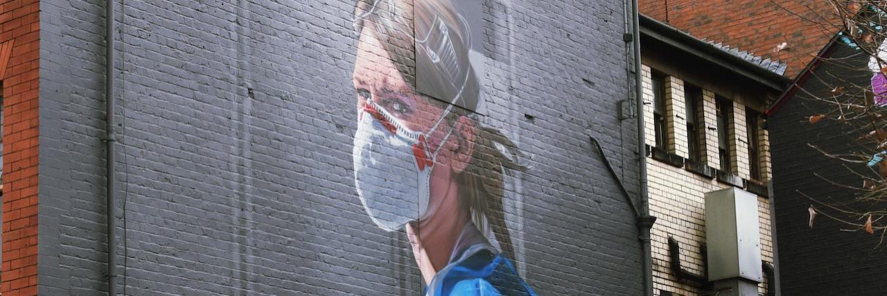 Street art of a nurse wearing a mask