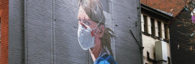 Street art of a nurse wearing a mask