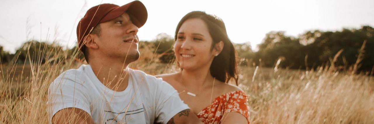 A couple holding each other in a wheat field