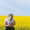 photo of woman in field of yellow flowers