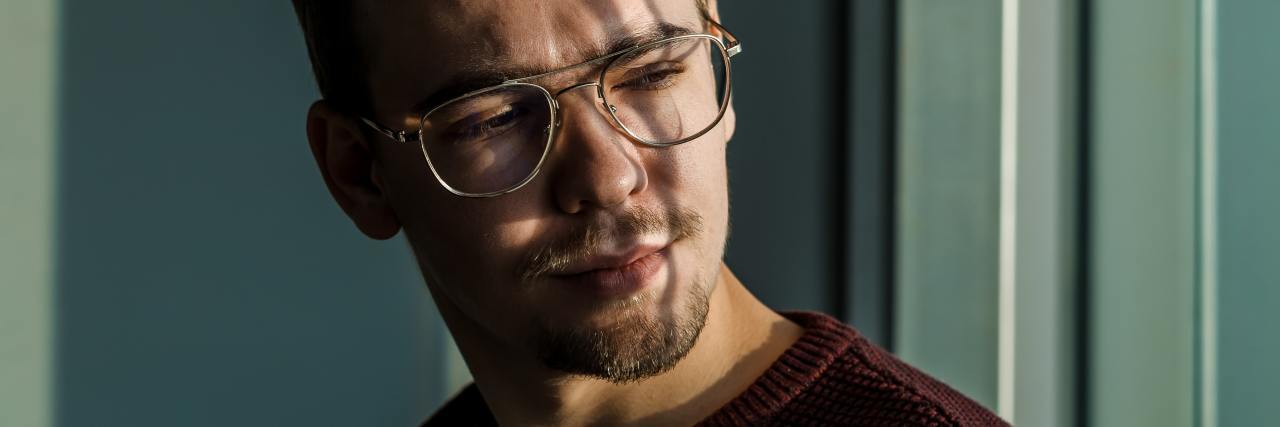 New Year's Resolutions With Chronophobia and Anxiety photo of a man sitting at a window with light falling on his face