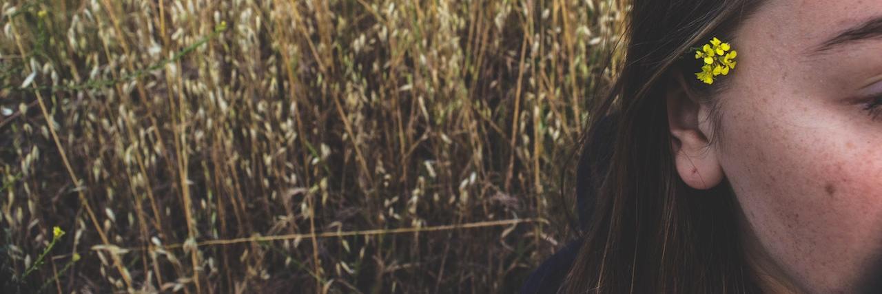 Healing After My Boyfriend's Suicide Sparked a Psychotic Episode A woman with a flower in her hair