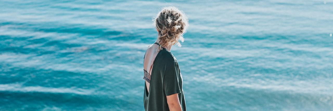 6 Lessons Living With OCD Has Taught Me photo of woman looking out to blue sea on bright sunny day