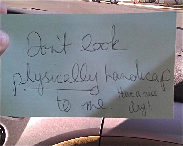 Rude note on Lori's wheelchair that says. "Don't look physically handicap to me."