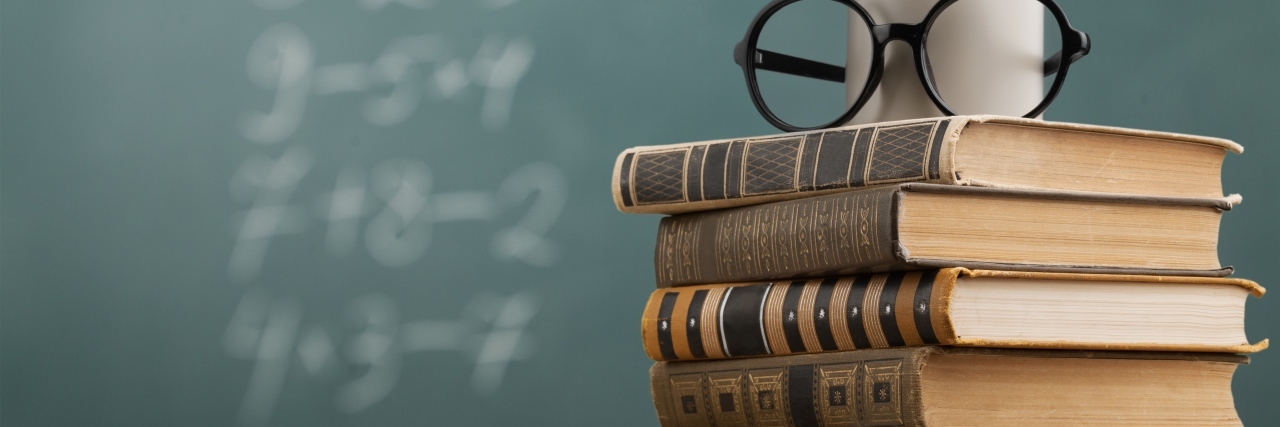 How Parents and Teachers Can Make IEP Meetings Better, Together Teacher's desk with books and chalkboard.