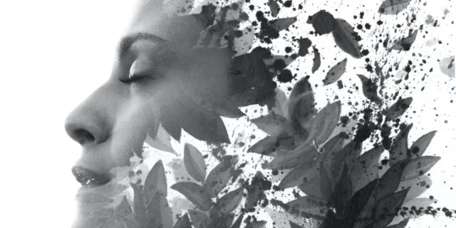 Double Exposure portrait of woman's profile combined with hand drawn watercolor painting of leaves and ink splash, black and white