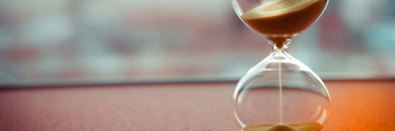 We Are The Sand in The Hourglass sand running though an hourglass