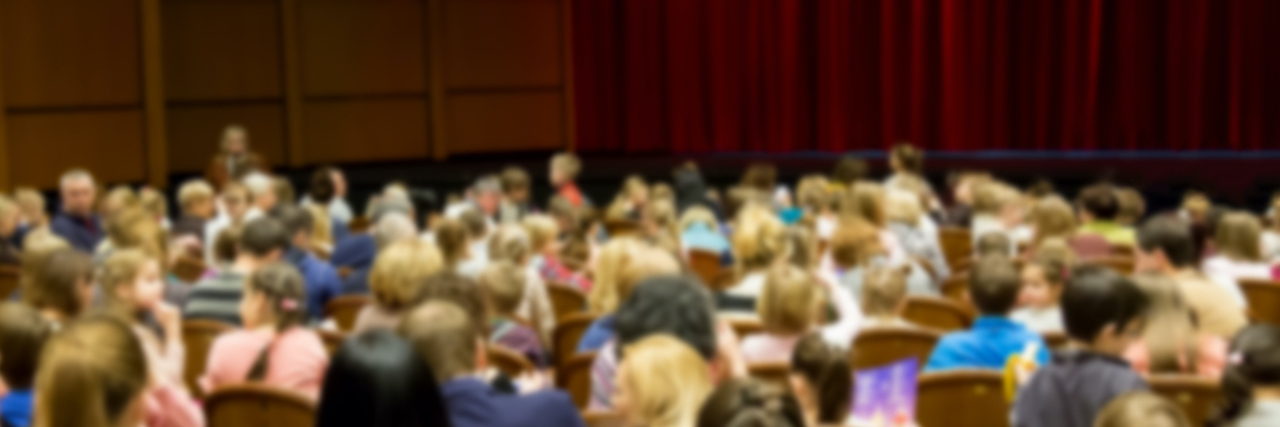 We Need to Better Protect Children From Sexual Abuse Unfocused, blurry image of young students in auditorium