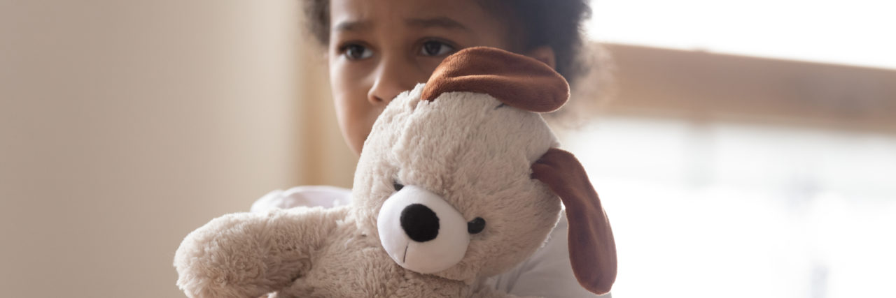 How Trauma Can Make You More Sensitive small Black boy holding a stuffed animal afraid