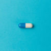 Medication capsule on blue background