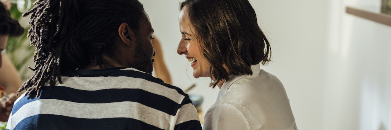 The Importance of Maintaining Relationships During the Pandemic A couple (a Black man and a White woman) hugging and looking at each other