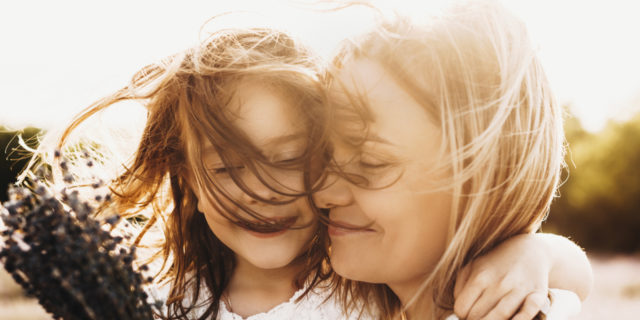 Achondroplasia Explained: Causes and What Families Should Know Girl embracing her mother.
