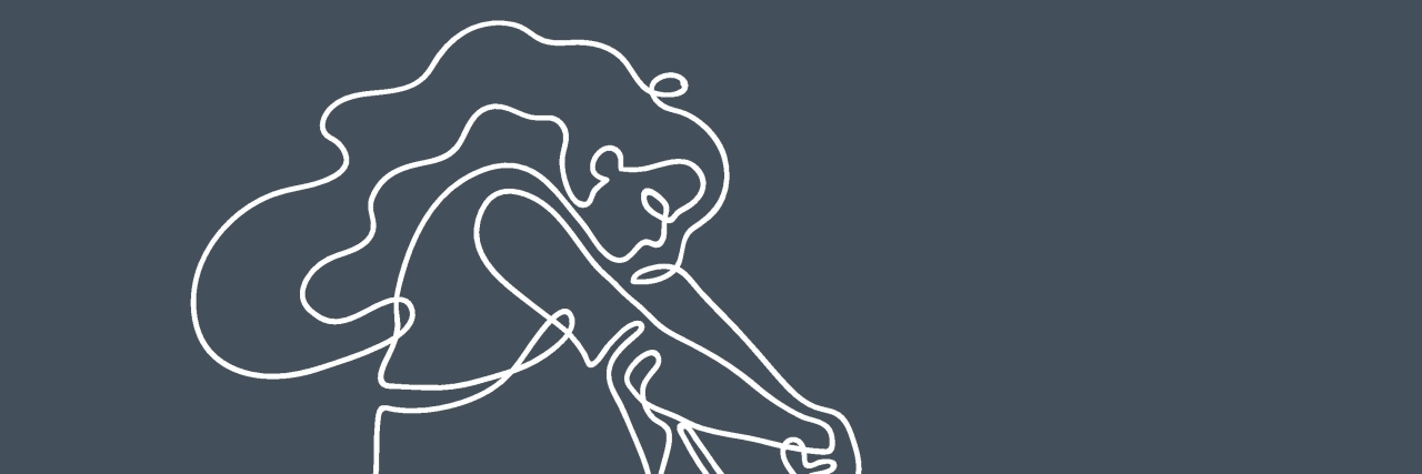 Feeling Sad While Grieving Is Different Than a Depressive Episode abstract image of a girl with long hair sitting on the floor, knees tucked to her chest, crying