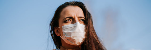 Woman in a medical mask on the street during the coronavirus pandemic.