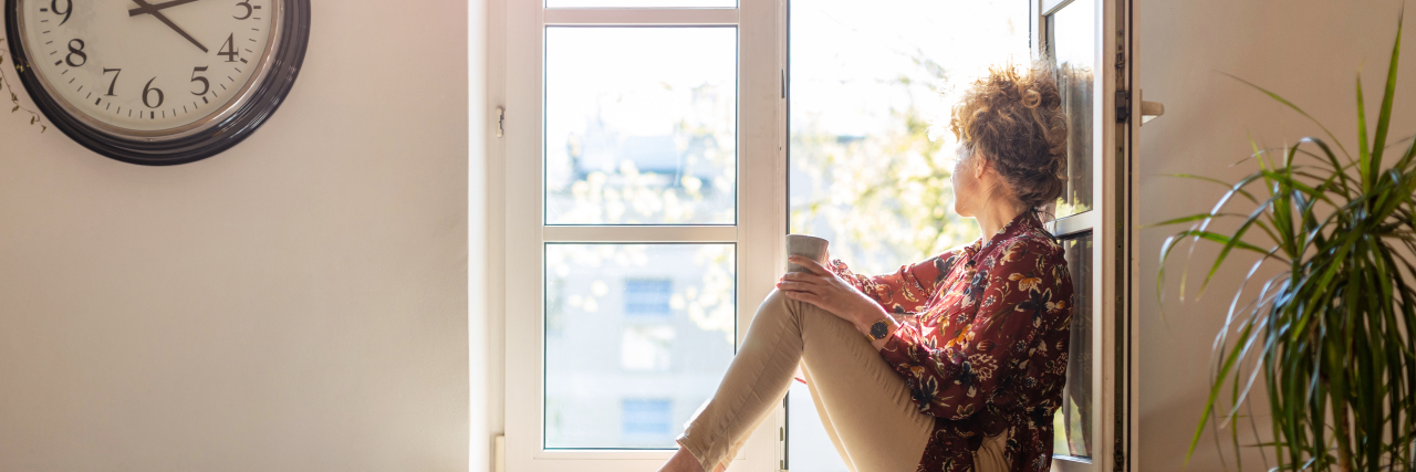 Why I Choose to Be Open About My Mental Health young woman looking out the window