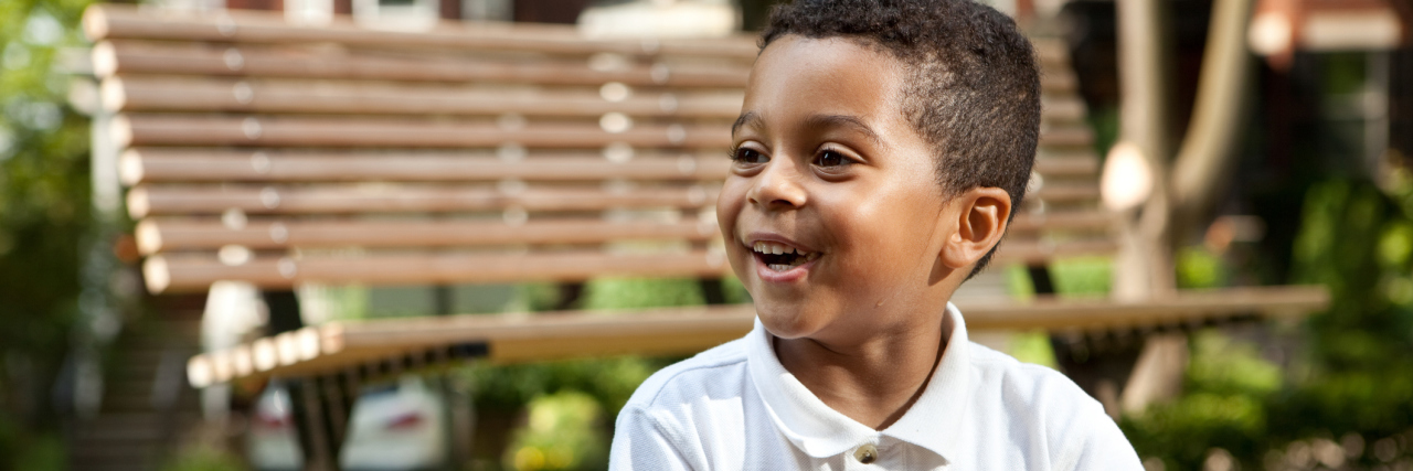 Young boy eating in a park