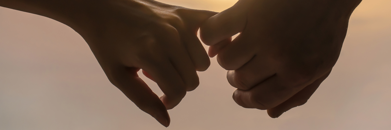 Dating and Marriage With Hemiplegic Migraine Couple holds each other's hands.