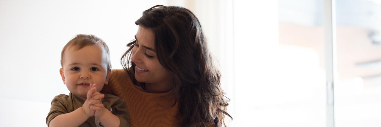 Avoiding the 'Blame Game' When Your Child Is Diagnosed With Autism Young mother playing with her baby at home.