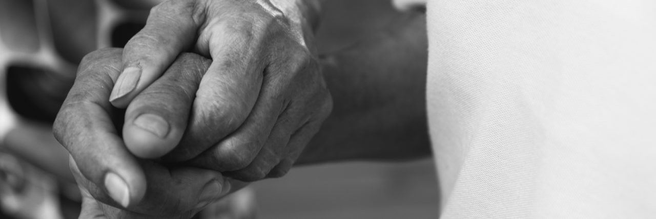 Caregivers Ineligible for COVID Vaccine Worry About Getting Sick Caregiver hand holding elder hand