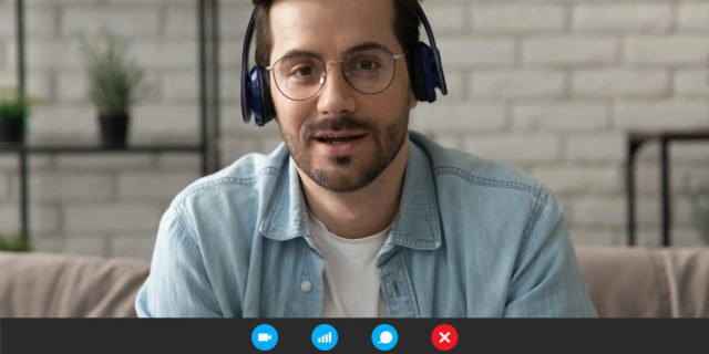 My Mixed Experiences With Virtual Healthcare Man wearing headphones on video call